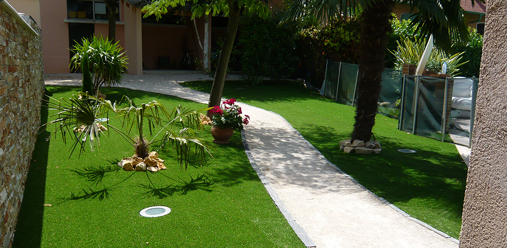 Artificial grass in a wooded garden