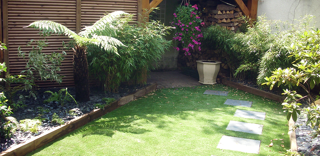 Artificial grass in a garden with Japanese flagstones